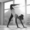 Woman exercising yoga at gym